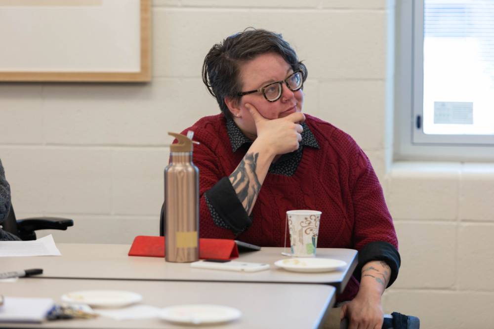Krista Benson, assistant professor of liberal studies, listens intently to a presentation.